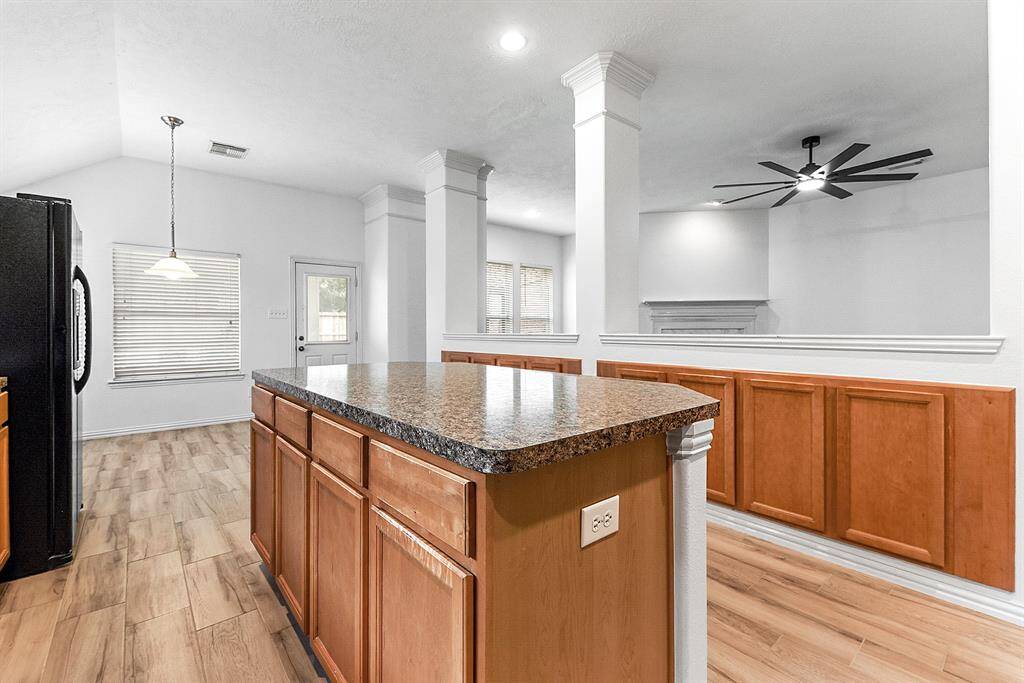 The kitchen’s functionality is excellent, featuring a great layout with tons of cabinetry and storage space. The island includes additional storage and a pony wall for a seamless transition to the living area.