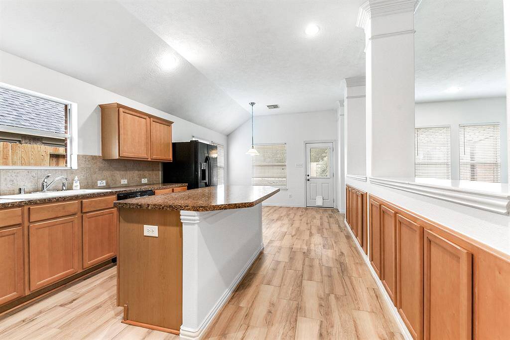 Stepping back, you can appreciate the amazing layout of this home, featuring a spacious kitchen designed for perfect functionality, complemented by a breakfast room with views of the backyard.