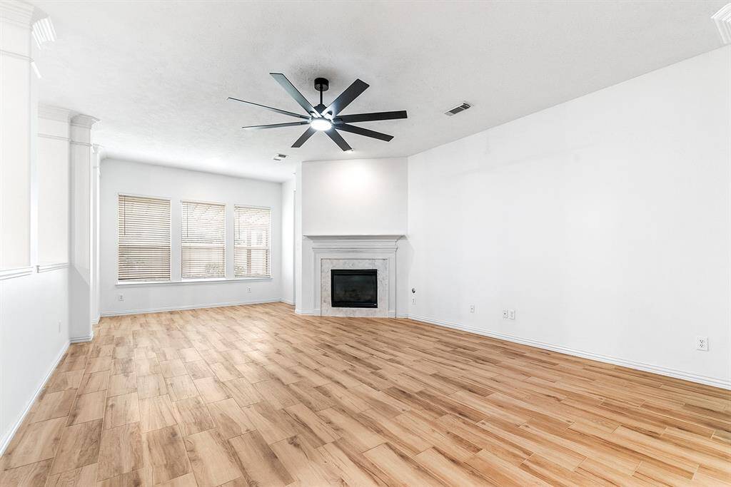 There’s plenty of room to accommodate any type of furniture layout in this living room, which is filled with abundant natural light. Large windows offer beautiful views of the expansive backyard, creating a serene atmosphere. Tucked in the corner is the primary en suite, offering a private retreat within the home.