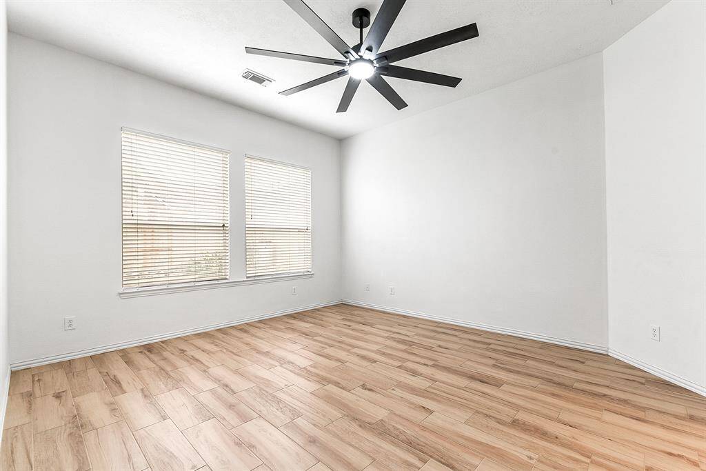 Your primary bedroom retreat features a private entrance off the living room hall, large windows overlooking the backyard, and plenty of space for all your large bedroom furniture.