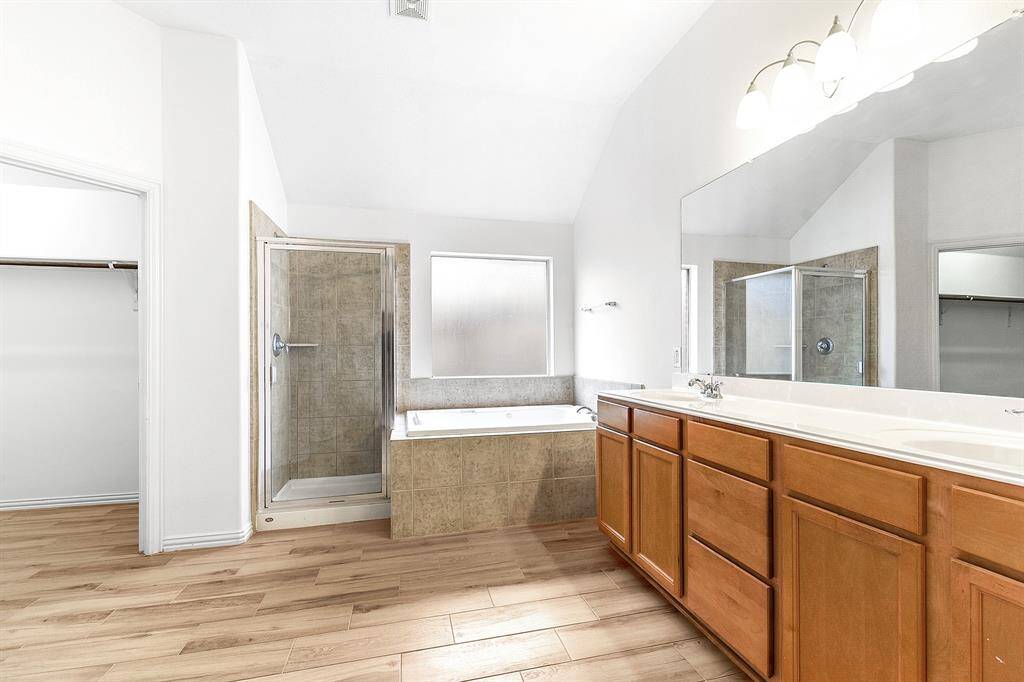 Another view showcases the spacious layout of the primary en suite.