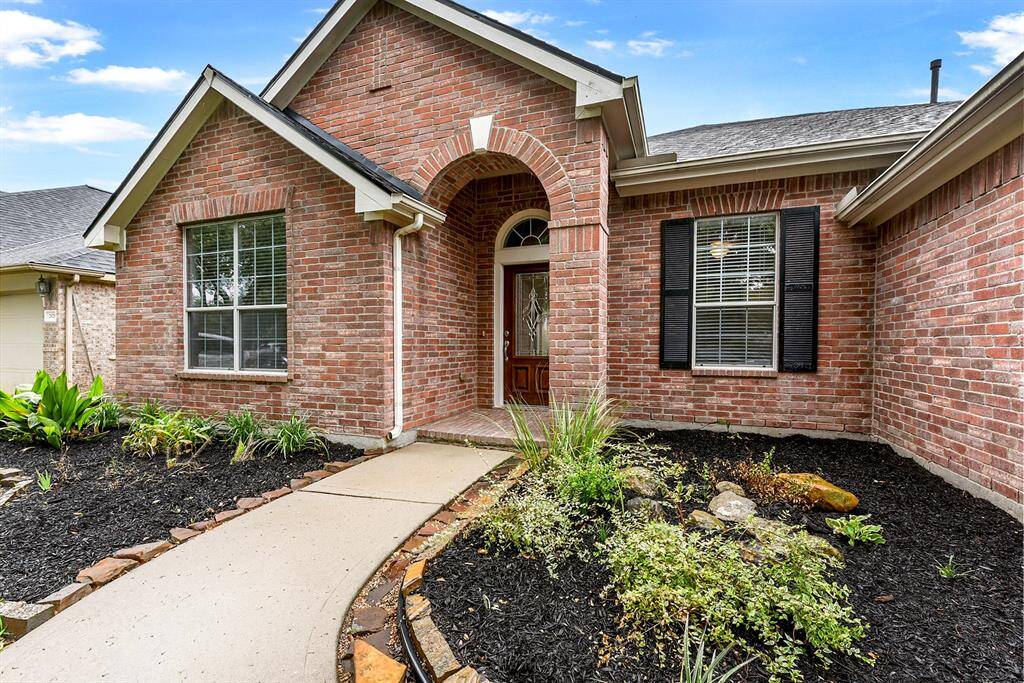 A welcoming walkway leads to the covered front entry, creating a warm and inviting first impression.