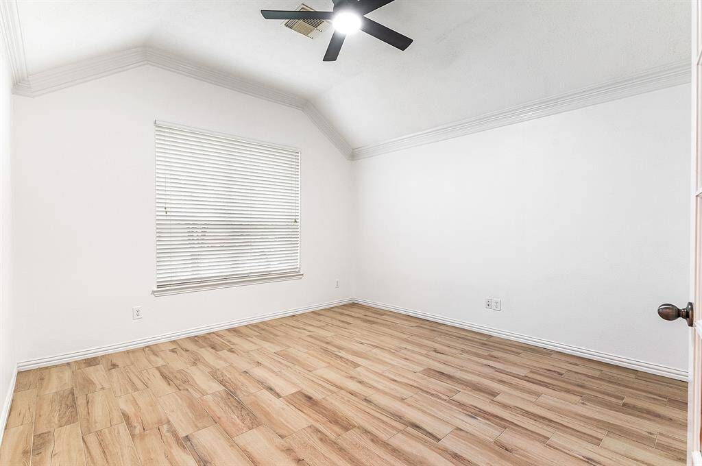 The home features higher ceilings, crown molding, elegant window treatments, and a new ceiling fan with remote control.