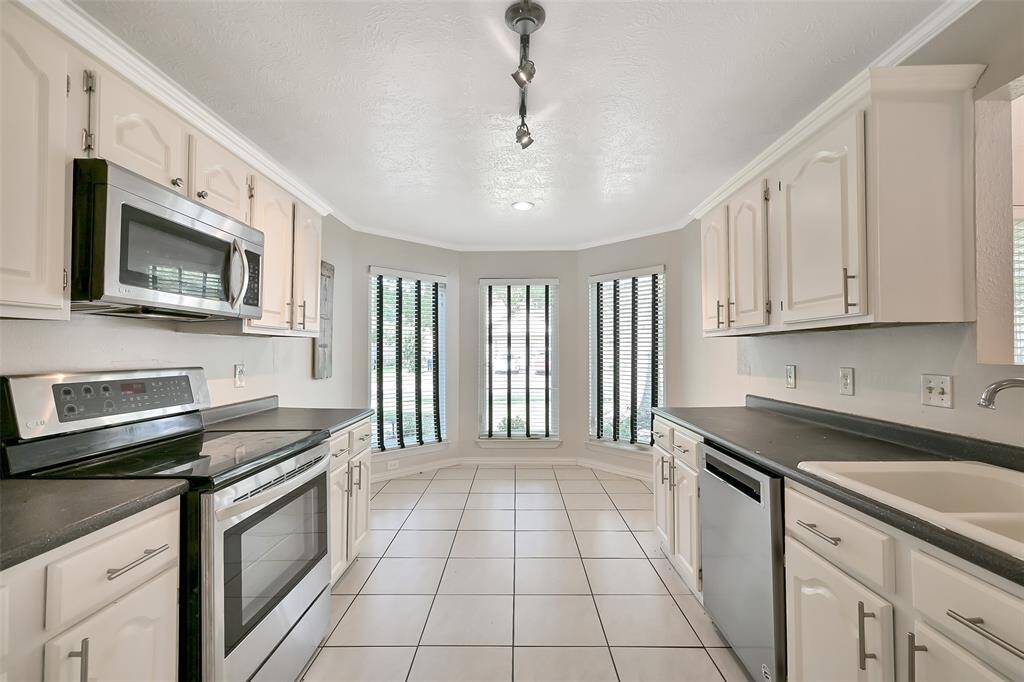 Kitchen with charming breakfast nook lined by bay windows