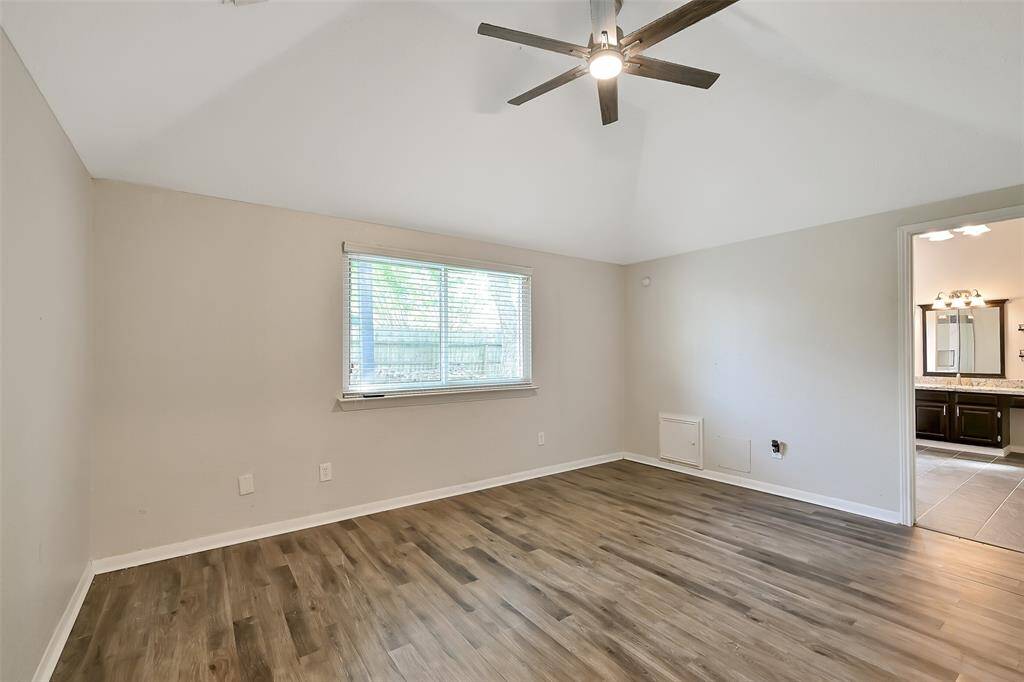 Large primary bedroom with high ceilings