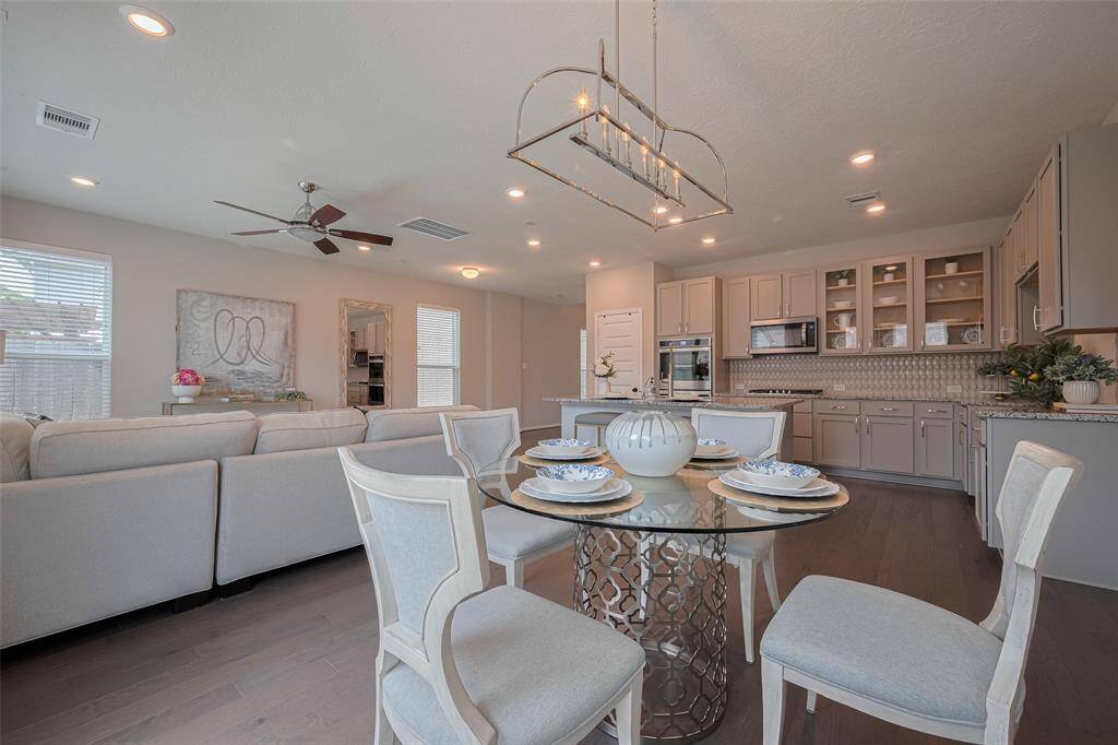 View from breakfast area to lovely kitchen and family room.