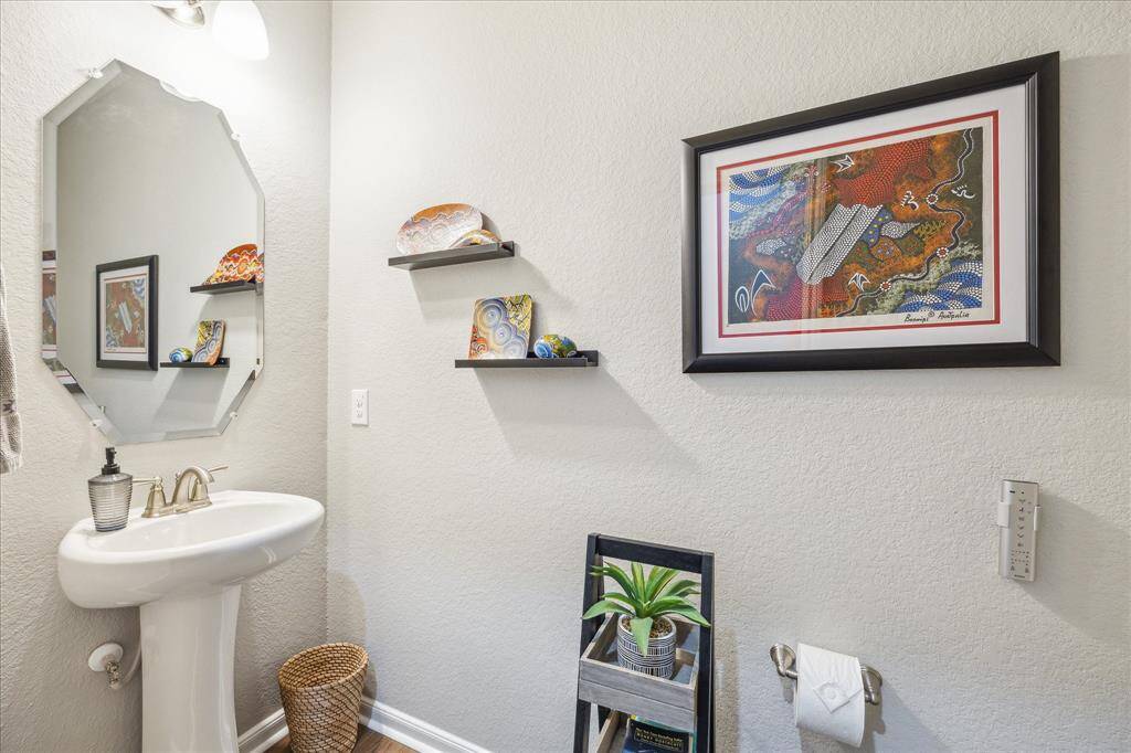 The lovely half bath features a pedestal sink and Toto toilet (another seller upgrade).