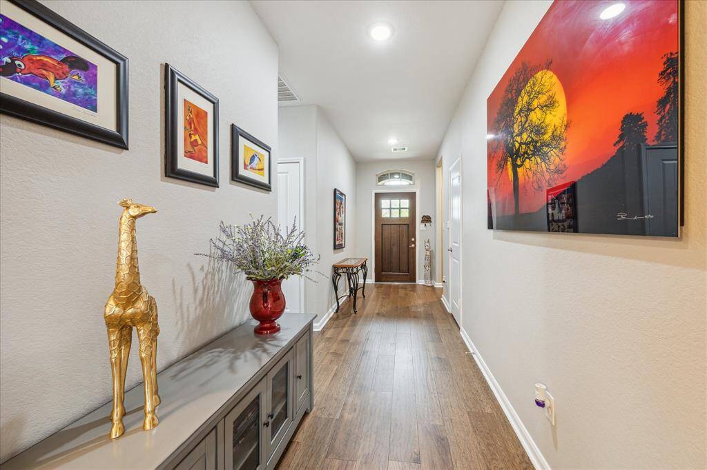 There have been numerous seller upgrades to this home over the past couple of years.  One of which is the gleaming engineered hardwood flooring found throughout the home; as seen in this photo of the entryway.