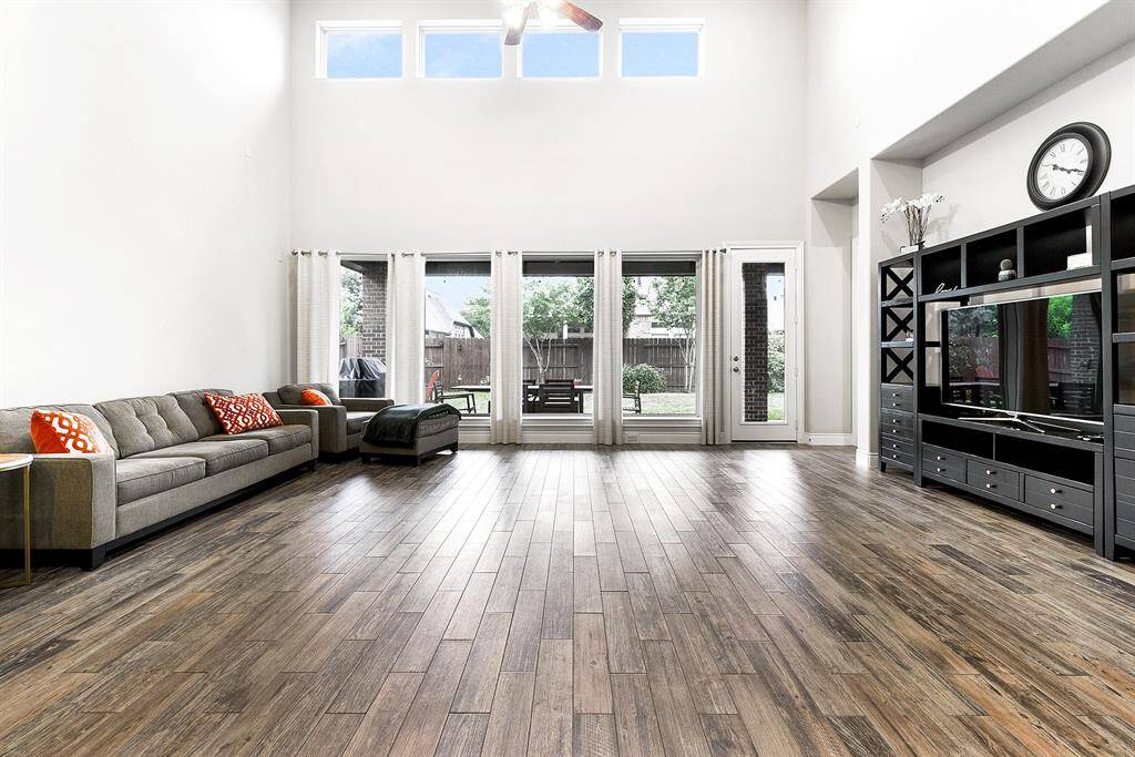 This huge living room features elevated ceilings, wood-like tile flooring, and a neutral color palette that flows throughout the entire home. Move-in ready and meticulously maintained, this turnkey property has been proudly owned by the original owner.
