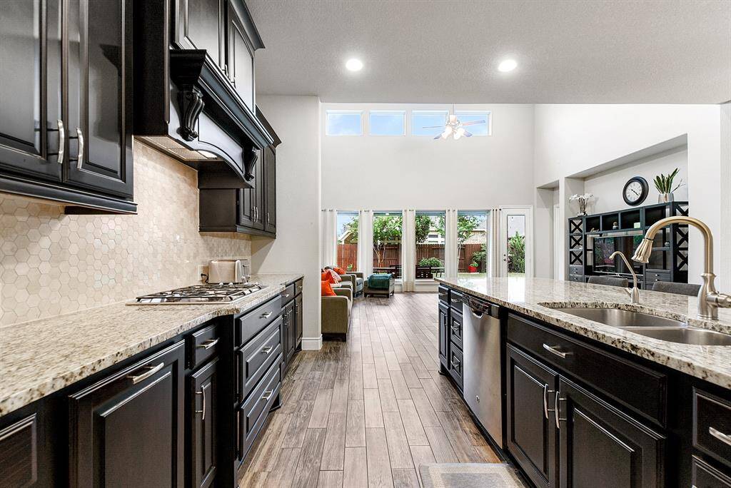 This beautiful kitchen features recessed lighting and numerous windows in the breakfast room and living area, allowing for abundant natural light. A huge island includes a sink and a raised bar for additional seating perfect for casual dining or entertaining.