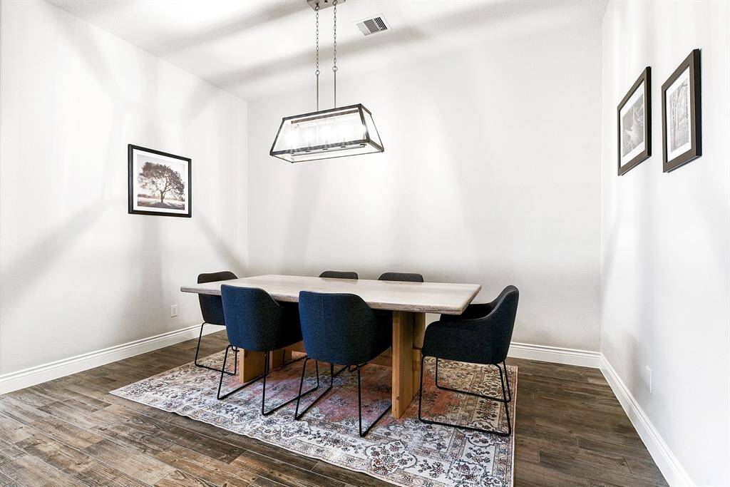 The formal dining room offers generous space, beautifully complemented by an updated drop-down chandelier