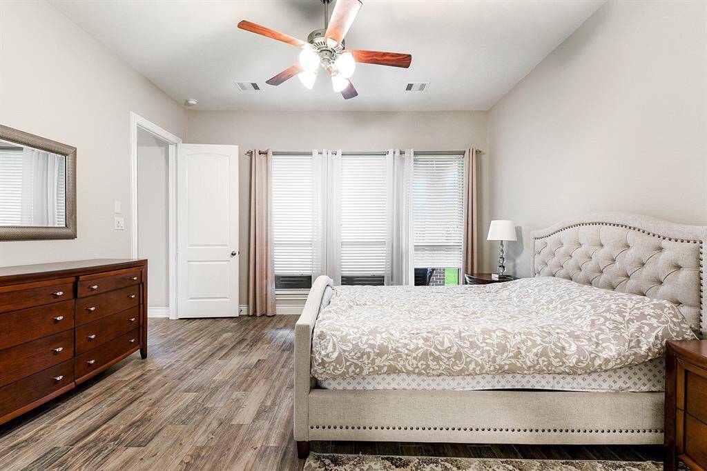 Nestled in the corner of the main floor is the primary en suite. Step into the spacious primary en suite – it's truly expansive! There's ample room for large furniture and even a separate seating area with a wall of windows overlooking the backyard.