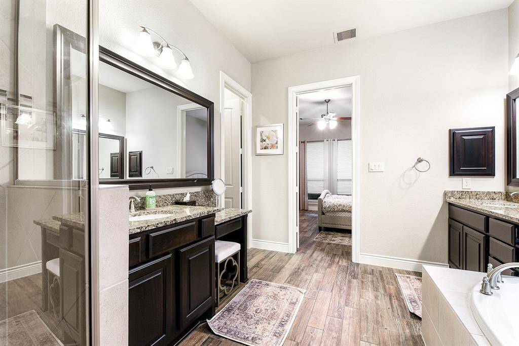 Another view showcasing the spaciousness of this en suite bathroom. This home features many upgrades throughout, including beautifully framed mirrors in the bathroom.
