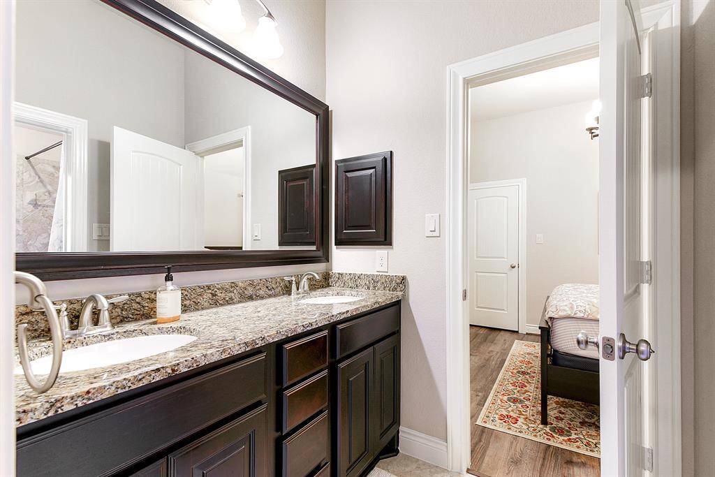 The shared two-piece bathroom between the two guest rooms features a shower/tub combo, with each room having its own door to the double sink vanity area for added privacy and convenience.