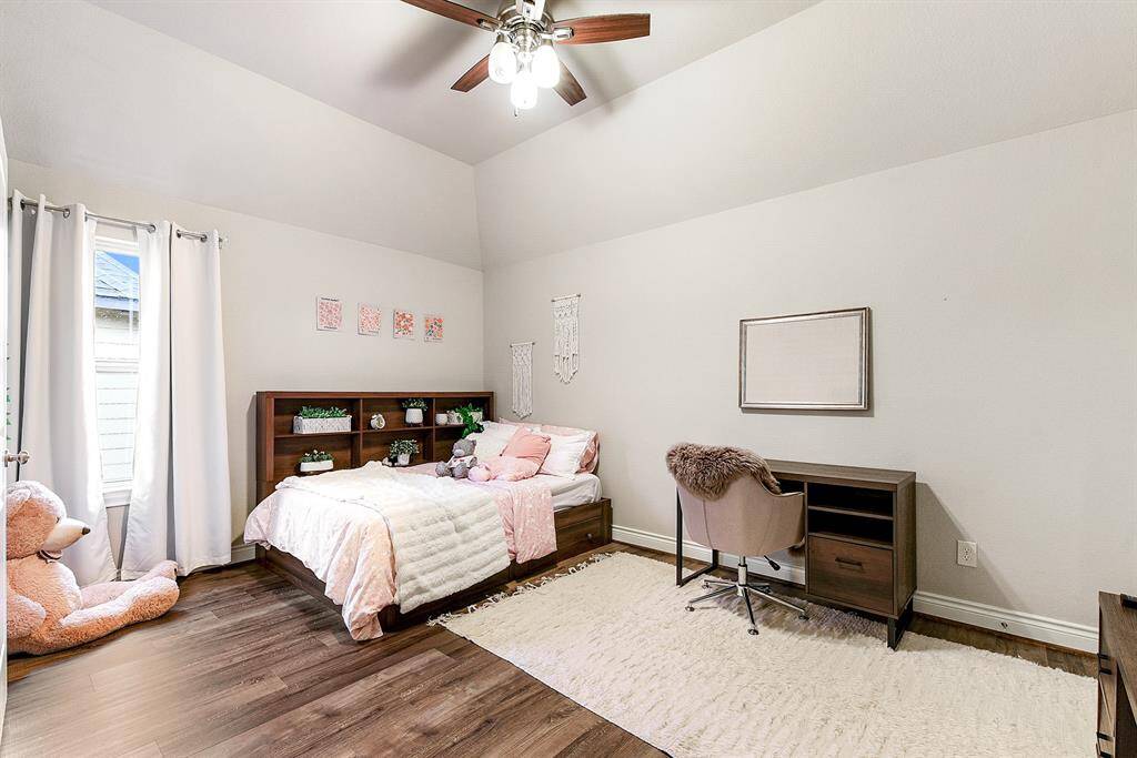 One of the four bedrooms, this guest bedroom features a Jack and Jill style bathroom connected to it, adding a touch of luxury and convenience. This bedroom also includes a large closet and a ceiling fan for added comfort.