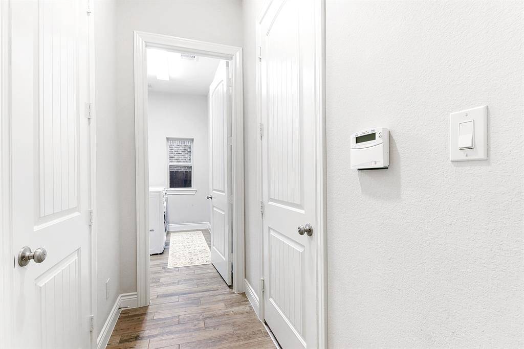 Step into the mudroom, offering a convenient and accessible space for storage. It provides direct access to the 2-car garage and the spacious utility room.