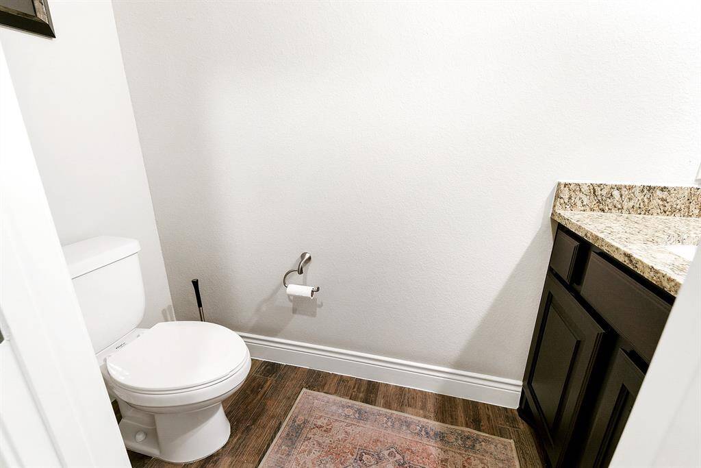 Downstairs offers a convenient powder room for guests, complete with a full vanity.