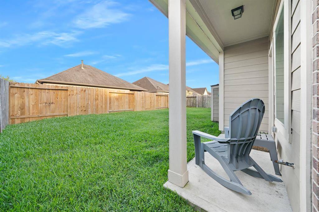 Fenced backyard with patio seating area