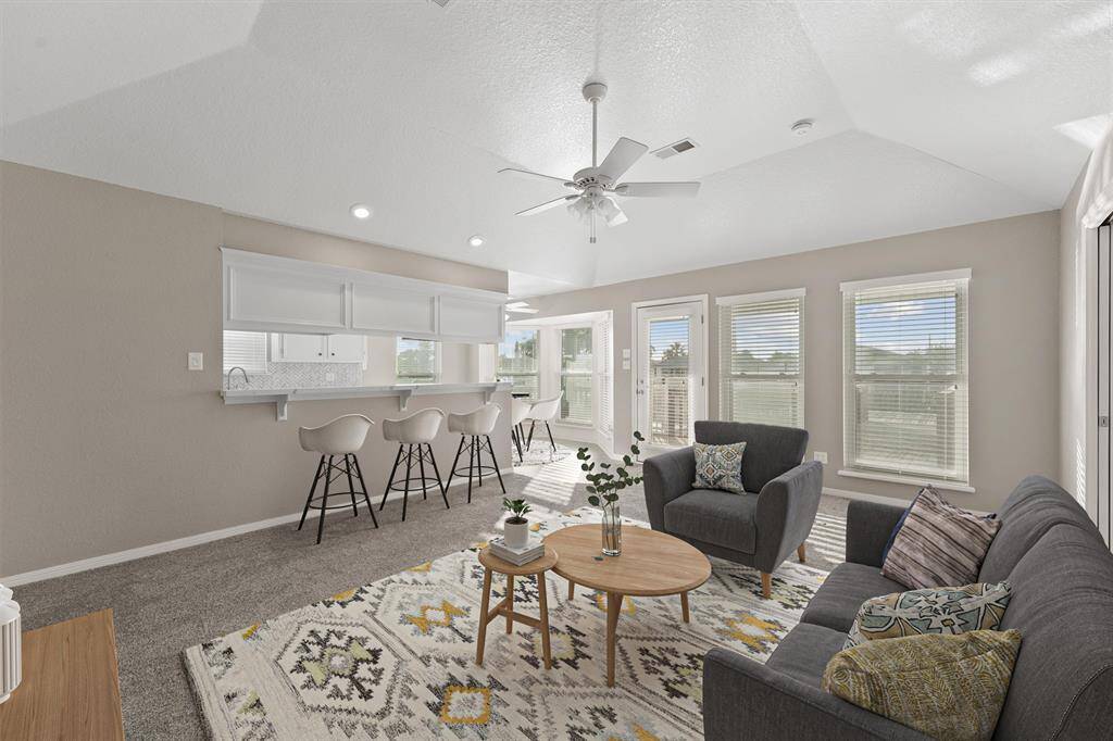 Spacious living area flows effortlessly into the kitchen and dining nook, with stylish furnishings and great natural light. Perfect for casual gatherings or cozy evenings.