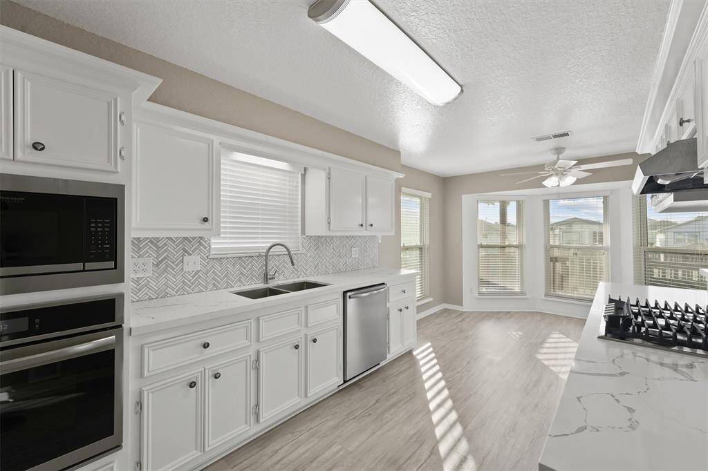 Wide galley-style kitchen blends form and function—ideal for prepping meals while staying connected to the living area and guests.