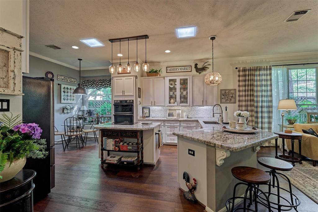 This timeless kitchen opens to the den with bonus island seating options - perfect for entertaining!