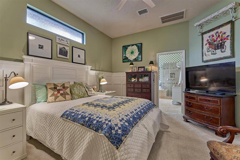Transom window offers additional natural light in this soothing space. Note the soothing color palette for added appeal.