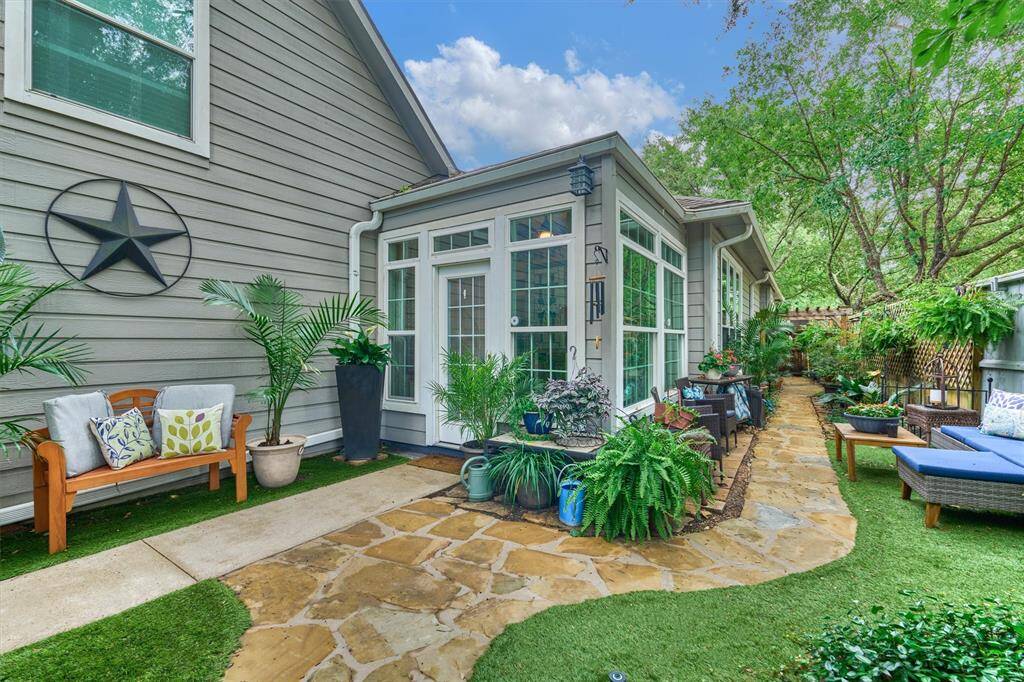 Enclosed patio/sun room with brick pavers, and convenient access to staircase leading to the garage apartment.