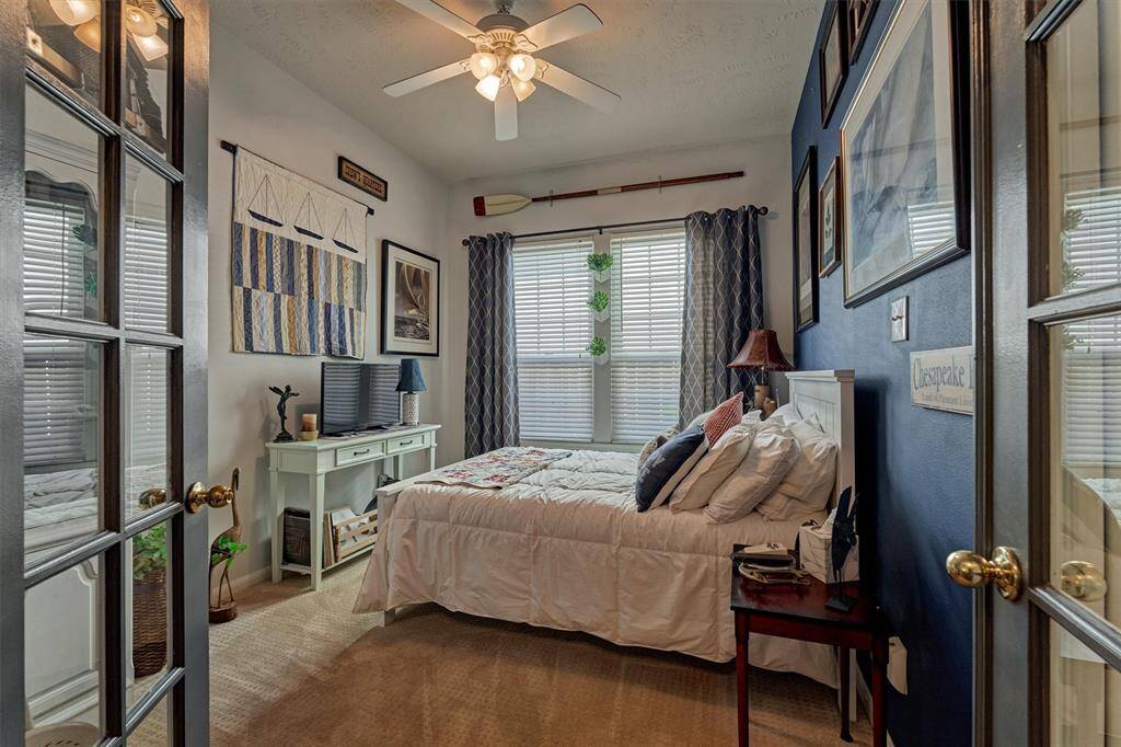 Navy accent wall perfectly completes the space in this secondary bedroom (optional home office).