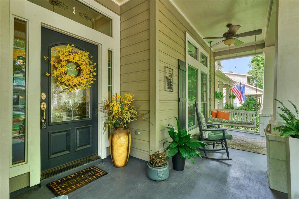 Inviting front porch with comfortable ventilation and stained concrete, front door entry with sidelites and transom window, clapboard shutters, and personality unlimited!
