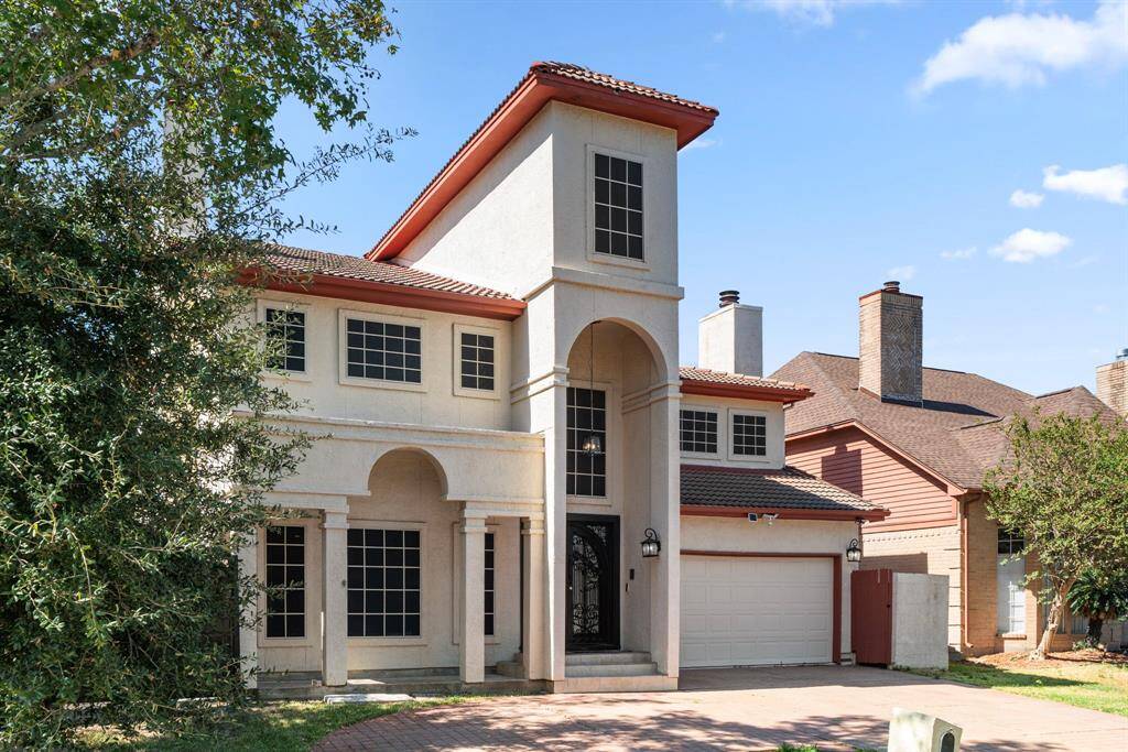 The tile roof contrasts beautifully with the light bright exterior