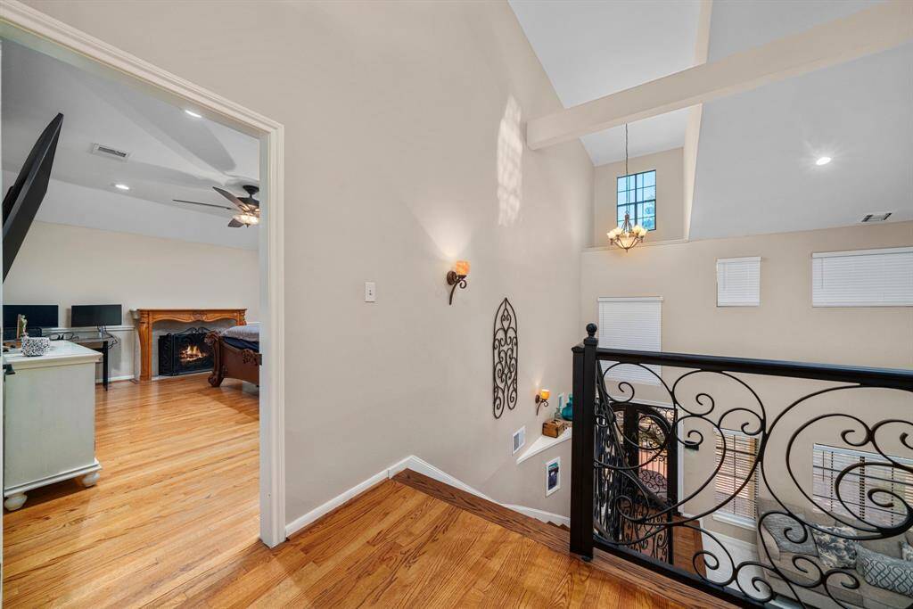 Upstairs landing with closer look up recently installed iron railing