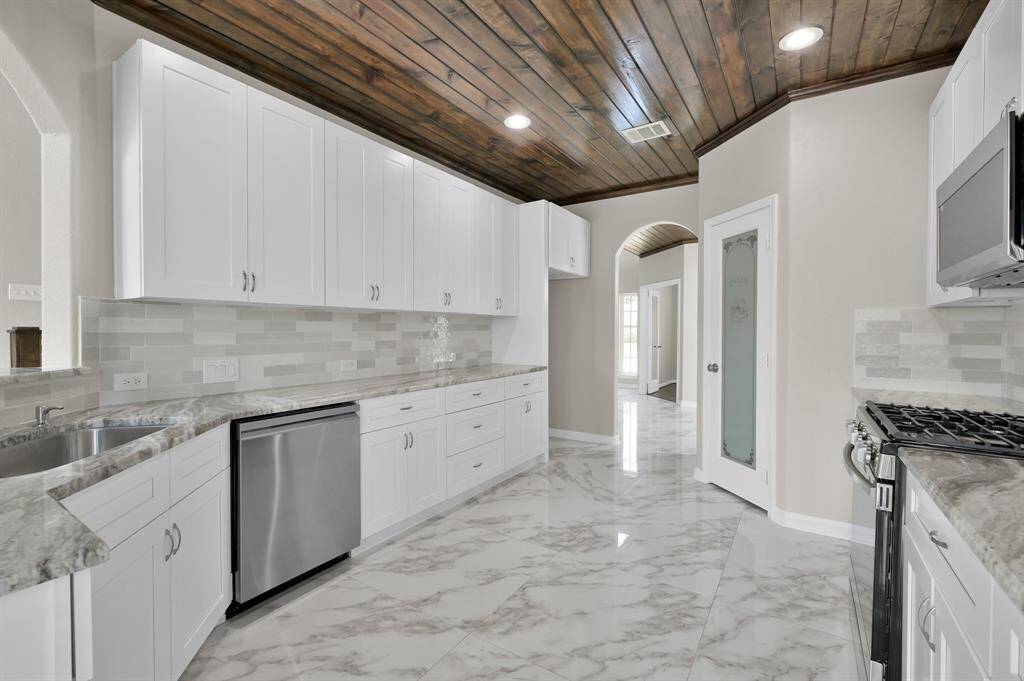 Kitchen with new appliances, granite counter tops, new sink and new garbage disposal. Pantry on the left. and dining room ahead