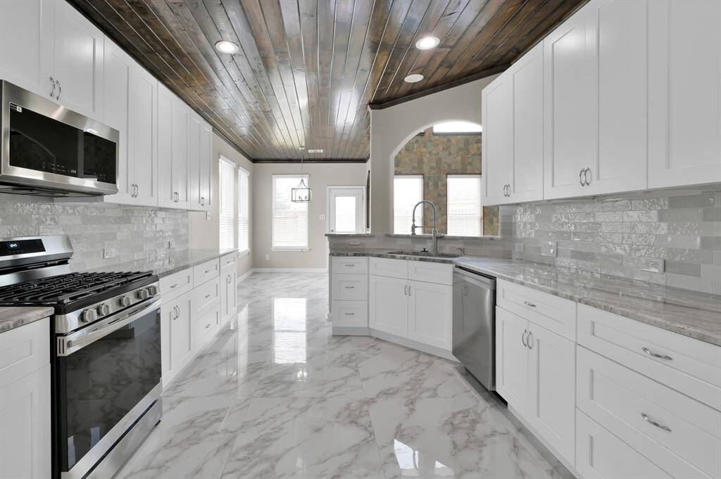 Kitchen and breakfast area straight with the back door.