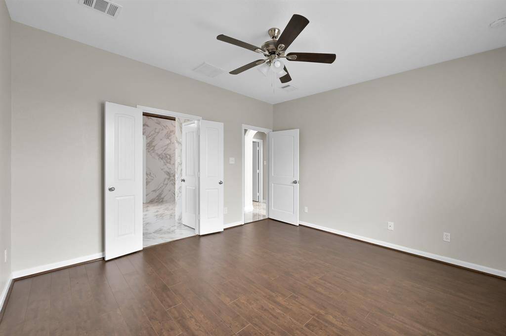Inside the Primary Bedroom. Primary Bath to the left, and the Living area on the right