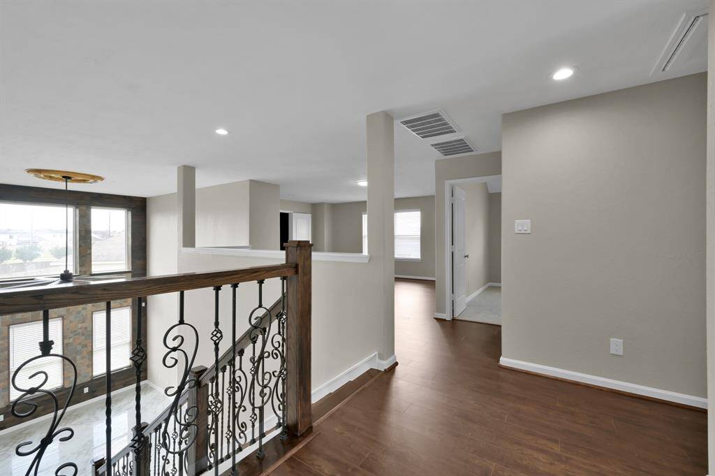 Upstairs Foyer with the staircase on the left, and Game Roomin the middle.