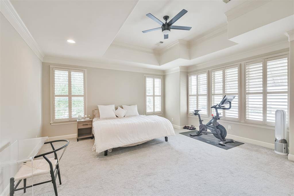 Bathed in natural light, thespacious primary suite offers apeaceful retreat with room for aPeloton or reading nook,complete with soft carpeting andtray ceilings.