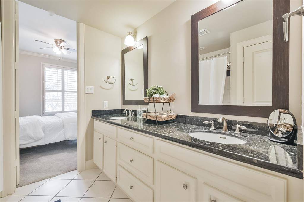 This elegant Jack and Jillbathroom features dual vanitieswith granite countertops andframed mirrors, offering bothstyle and functionality for sharedliving.