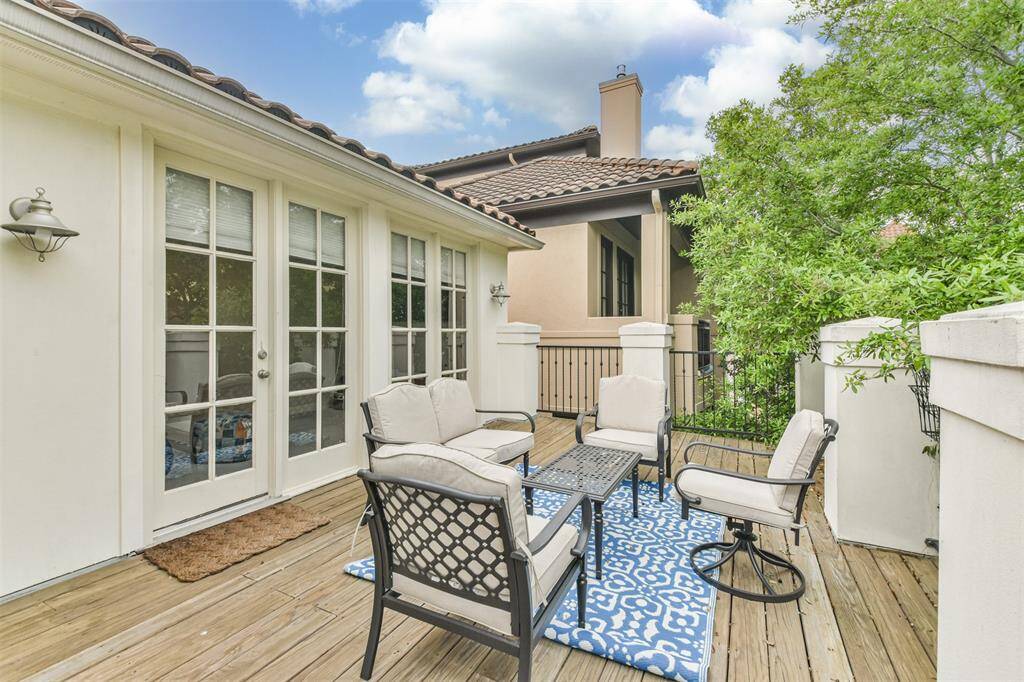 This elevated terrace offers aprivate outdoor retreat with lushgreenery, Spanish tile accents,and elegant French doors thatlead back into the home.