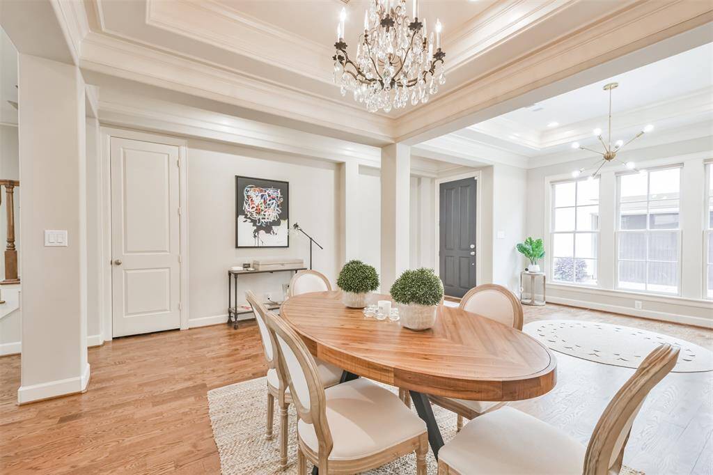The elegant dining roomseamlessly connects to the mainliving space and bathed innatural light. Warm hardwoodfloors run through the home'smain areas.