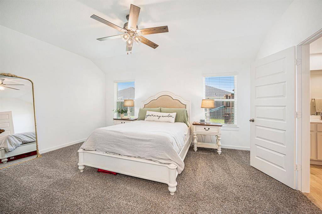 Relax in the spacious primary bedroom located at the back of the home, offering a quiet retreat with ample room and a peaceful atmosphere.