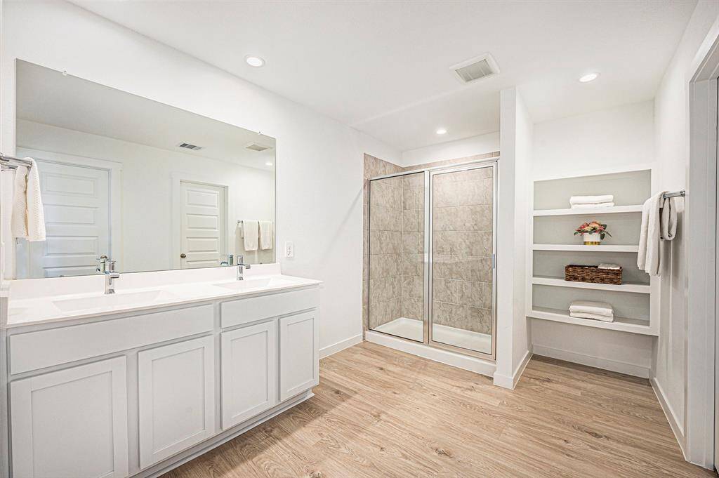 You don't have to share! The double sink vanity and oversized mirror lends itself to harmonious mornings.