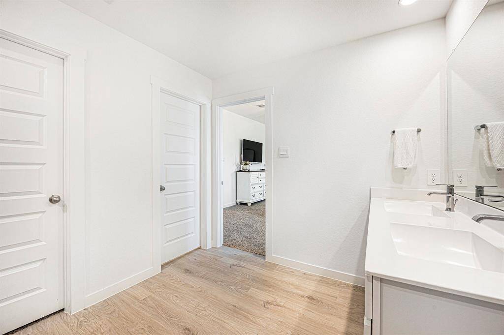 Spacious primary bathroom featuring a walk-in closet