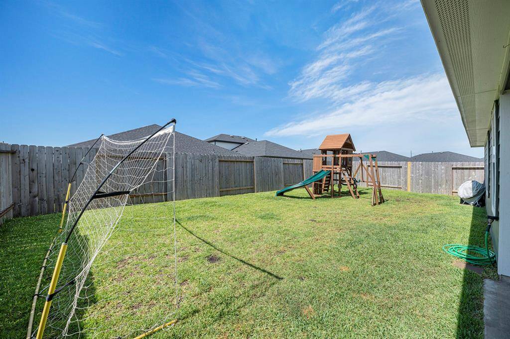 Fully fenced backyard, ideal for pets, play, and outdoor gatherings.