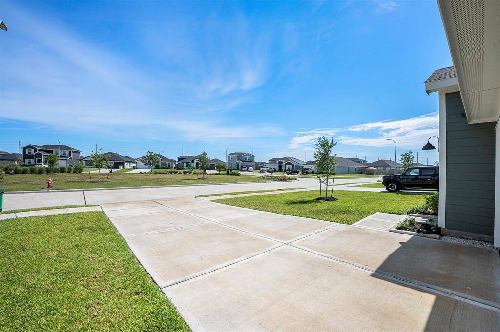 Expansive green space located out front, perfect for outdoor activities, relaxing, and enjoying the fresh air.