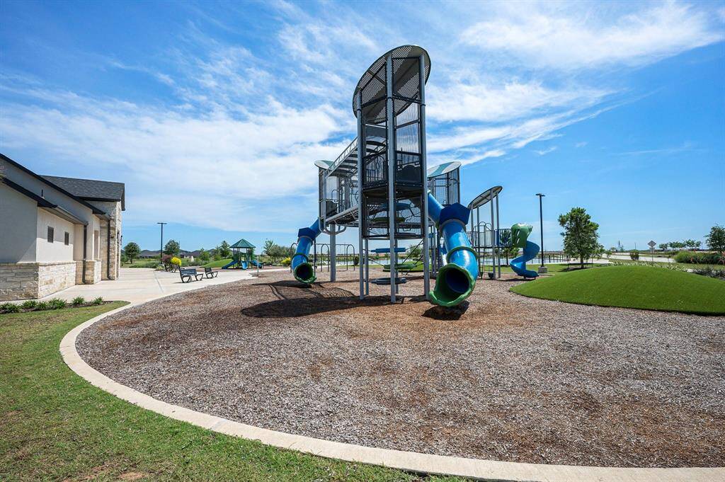 Just around the corner from the playground, a beautiful water feature awaits—perfect for peaceful evening strolls and enjoying the outdoors.