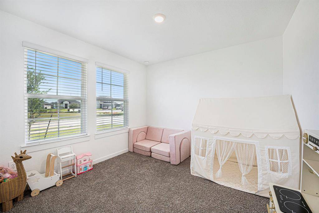 Stretch out and relax in cozy comfort in this secondary bedroom. The light pouring in from the windows makes the space bright and inviting.