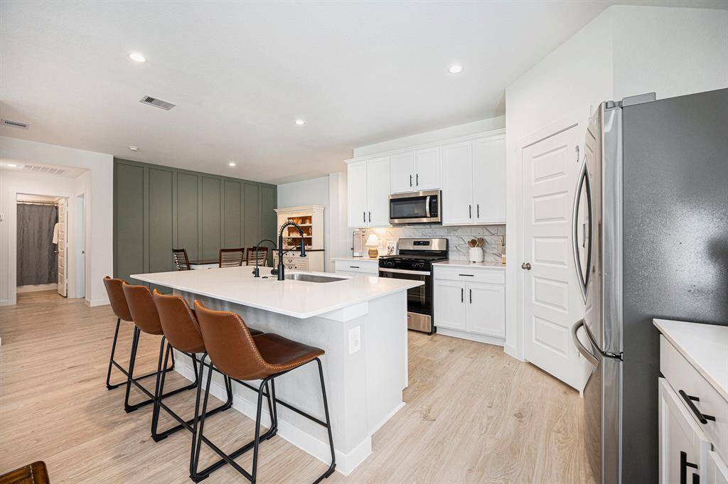 Sleek and functional kitchen with a large island and striking black hardware—offering the perfect blend of modern design and everyday convenience.