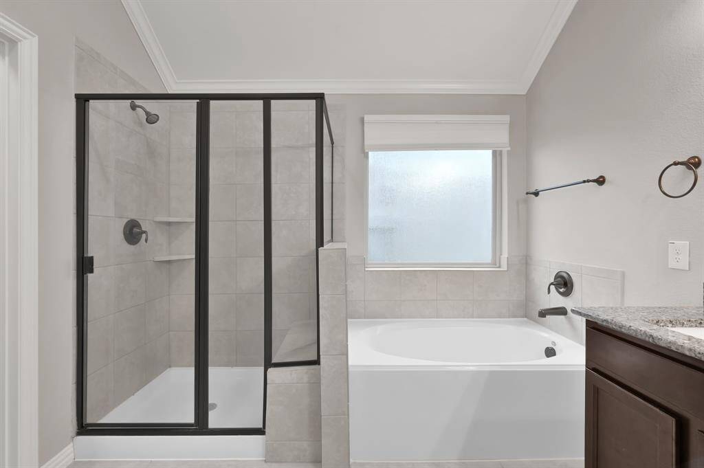 Oversized shower w/ separate soaking tub to melt away the days stress.