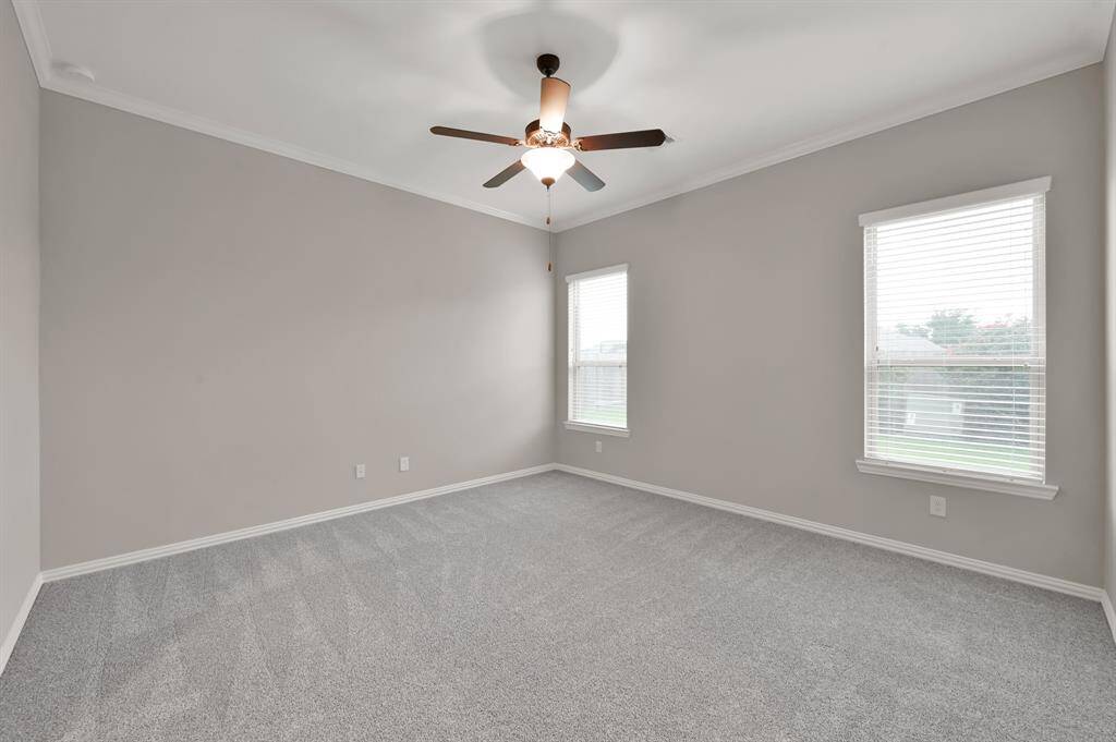 Master suite w/ natural light overlooking backyard.