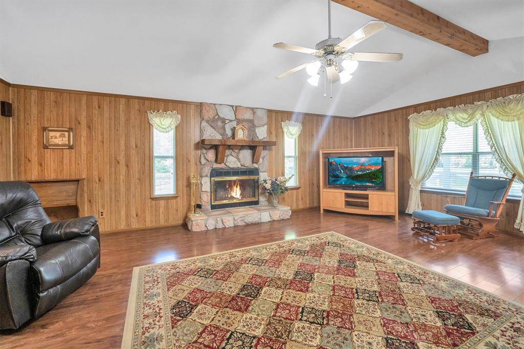 Large den with faux cedar wrapped beam